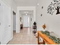 Bright foyer with tile flooring, neutral walls, and decorative accents leading to a well-lit entrance at 5718 Broad River Run, Ellenton, FL 34222