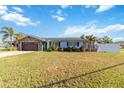 Beautiful single-story home features mature landscaping and an attached two-car garage at 6001 Firefly Ln, Apollo Beach, FL 33572