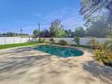 Inviting backyard featuring a sparkling private pool, surrounded by a spacious patio area, greenery, and white vinyl fence at 6226 21St N Ave, St Petersburg, FL 33710