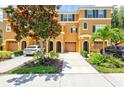 Three story townhome with a two-car garage and landscaped yard at 7350 Black Walnut Way, Lakewood Ranch, FL 34202