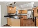 Kitchen features light wood cabinets, granite counters, and stainless steel appliances at 7805 Capwood Ave, Temple Terrace, FL 33637