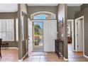 Inviting home foyer with tiled floor, arched transom and open floor plan at 8727 Grey Oaks Ave, Sarasota, FL 34238