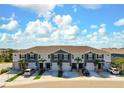 An aerial view of the townhome exteriors showcases landscaping, private driveways, and ample parking at 8737 Daydream St, Sarasota, FL 34238