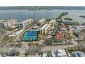 Aerial view showcasing condo community near water, tennis courts at 8767 Midnight Pass Rd # 505F, Sarasota, FL 34242