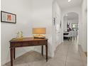 Bright entryway with console table and view into dining area at 8995 Milestone Dr, Sarasota, FL 34238