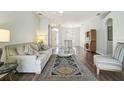 Open living room featuring a large rug, hardwood floors, and lots of natural light at 10726 Old Grove Cir, Bradenton, FL 34212