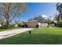 Lovely home featuring a well-kept lawn and a convenient two-car garage at 1208 Francis Ave, Sarasota, FL 34232