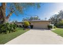 Inviting single-story home with a long driveway leading to a spacious two-car garage at 1208 Francis Ave, Sarasota, FL 34232