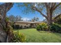 Serene view of a home nestled among lush landscaping, showcasing its curb appeal at 1208 Francis Ave, Sarasota, FL 34232