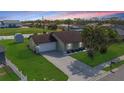 An aerial view of a cozy home featuring a manicured lawn, mature trees, and a lengthy driveway at 1406 14Th Street W Ct, Palmetto, FL 34221