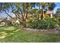 Beautiful yard with mature trees and professional landscaping at 1529 Oak Way, Sarasota, FL 34232