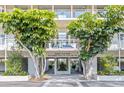 Welcoming entrance to Building Six & Seven, featuring lush greenery and modern architectural design at 225 Sands Point Rd # 6204, Longboat Key, FL 34228