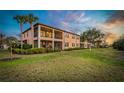 Enjoy the outdoors from this backyard view, complete with a screened-in porch and lush green grass at 23189 Banbury Way # 203, Venice, FL 34293
