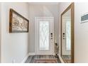 Elegant entryway with a stylish front door, ornate mirror, and decorative accents at 2622 Light Sky Ln, Bradenton, FL 34211