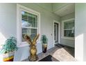 Cozy front porch with decorative plants, an eagle statue, and a welcoming entrance at 2622 Light Sky Ln, Bradenton, FL 34211