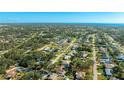 Scenic aerial view of the property in a tranquil neighborhood surrounded by trees and nearby amenities at 2760 Siesta Dr, Venice, FL 34293