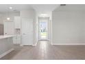 Bright entryway with tile flooring, white walls, and a view of the front door at 3166 Cabo St, North Port, FL 34291