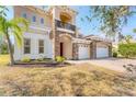 Charming home with a red door, stone accents, and a three-car garage with brick paved driveway at 4307 70Th E Ave, Ellenton, FL 34222