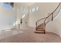 Grand two-story foyer with curved staircase, neutral carpet, and an abundance of natural light at 4307 70Th E Ave, Ellenton, FL 34222