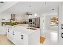 Bright kitchen featuring white cabinets, stainless steel appliances, and a spacious center island at 5107 Saint Albans Ave, Sarasota, FL 34242