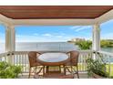 Relaxing covered balcony offers breathtaking water views, wicker seating, and a peaceful setting at 5282 Beach Se Dr # D, St Petersburg, FL 33705