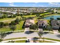Community overview featuring houses, green spaces and lake at 5639 Rain Lily Ct, Sarasota, FL 34238
