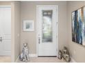 Bright entryway with white door and decorative accents at 5639 Rain Lily Ct, Sarasota, FL 34238