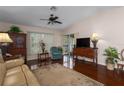 Cozy living room with hardwood floors, ceiling fan, and comfortable seating arrangement at 5441 18Th W Ct, Bradenton, FL 34207
