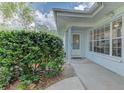 Inviting front entrance with a well-kept garden and a cozy covered porch at 6517 Approach Rd # 57, Sarasota, FL 34238