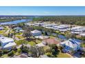 Picturesque aerial view of a waterfront neighborhood next to canal and green spaces at 907 Garland Ave, Nokomis, FL 34275