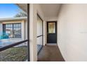 Covered front porch with decorative door and gravel accents, enhancing curb appeal at 1058 Bounds St, Port Charlotte, FL 33952