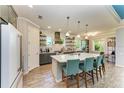 Spacious kitchen featuring modern appliances and a large island with barstool seating at 12514 Goldenrod Ave, Bradenton, FL 34212