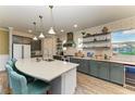 Modern kitchen featuring stainless steel appliances, a large island, and ample counter space at 12514 Goldenrod Ave, Bradenton, FL 34212
