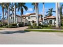 Beautiful two-story home with lush landscaping, a paver driveway, and mature palm trees surrounding the property at 13315 Palmers Creek Ter, Lakewood Ranch, FL 34202