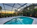Enclosed pool featuring clear water, poolside lounge chairs, and tropical landscaping at 14510 Leopard Creek Pl, Lakewood Ranch, FL 34202