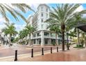 Beautiful exterior view of the building, complemented by palm trees and a welcoming street view at 1500 State St # 305, Sarasota, FL 34236