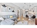 Stylish living room with modern furniture, art, and an open layout leading to the kitchen at 1500 State St # 305, Sarasota, FL 34236