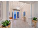 Elegant foyer with tile flooring, decorative columns, recessed lighting, and decorative glass french doors at 15115 Montello Way, Lakewood Ranch, FL 34211