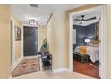Inviting hallway with tile flooring leading to a bedroom with ceiling fan at 1771 Ringling Blvd # 703, Sarasota, FL 34236
