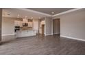 Open-concept living room with hardwood floors connected to a modern kitchen at 26902 Victoria Pl, Punta Gorda, FL 33955