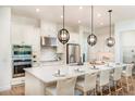 Bright kitchen featuring an island with seating, stainless steel appliances, and pendant lighting at 26908 Victoria Pl, Punta Gorda, FL 33955