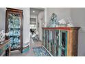 Nicely decorated foyer with display cabinet and view to the living room at 2838 Newbern Banks Dr, Bradenton, FL 34208