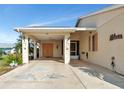 Covered carport featuring dolphin paintings and decorated with pelican and seashell art at 303 Grayston Pl # C133, Sun City Center, FL 33573