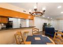 Inviting dining area adjacent to the kitchen, featuring a charming chandelier, wood table set, and easy access to living area at 3231 Beneva Rd # 101, Sarasota, FL 34232