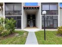 Inviting condo exterior with well-maintained lawn and direct access to upper and lower units, with beautiful plants and an address marker at 3231 Beneva Rd # 101, Sarasota, FL 34232