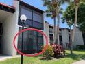 A bright and airy exterior view showcasing the well-maintained facade of this multi-unit residential building with lush greenery at 3231 Beneva Rd # 101, Sarasota, FL 34232