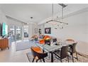 Modern living area featuring unique lighting, glass dining table, and colorful decor with access to the balcony at 332 Cocoanut Ave # 406, Sarasota, FL 34236