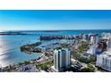 Breathtaking aerial view of a coastal city showcasing the marina, cityscape, and waterfront luxury living at 340 S Palm Ave # 152, Sarasota, FL 34236