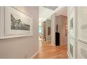 Bright hallway features modern art, light wood floors, and leads to a living area with stunning views at 340 S Palm Ave # 152, Sarasota, FL 34236