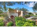 Charming single-story home featuring a mix of light and dark landscaping and a stone wall facade accent at 3417 Tallywood Ln, Sarasota, FL 34237